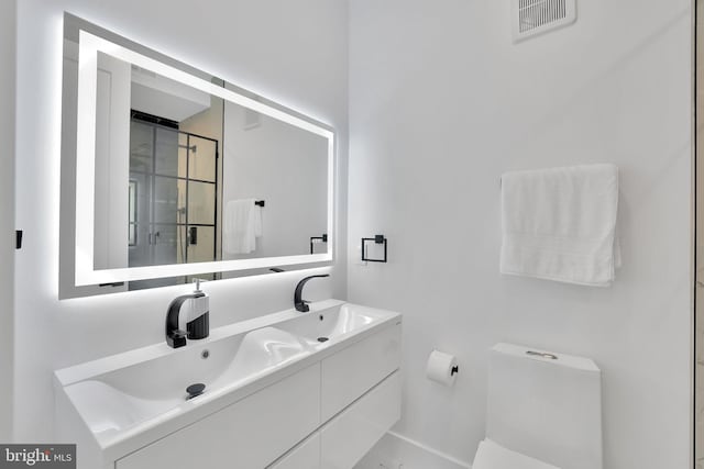 bathroom with vanity and toilet