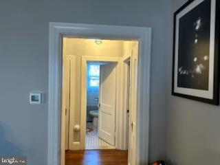 hallway with dark hardwood / wood-style floors