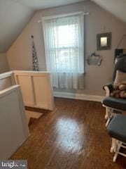 additional living space featuring dark hardwood / wood-style floors and lofted ceiling