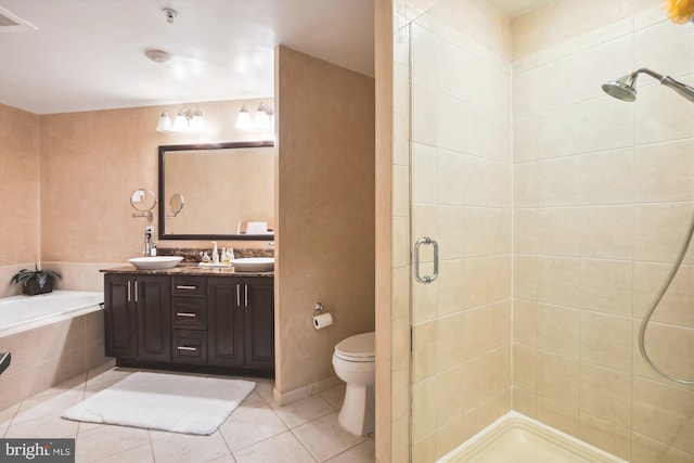 full bathroom featuring tile patterned flooring, vanity, separate shower and tub, and toilet