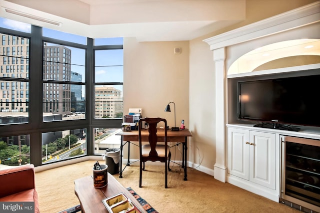 carpeted home office featuring beverage cooler and bar area