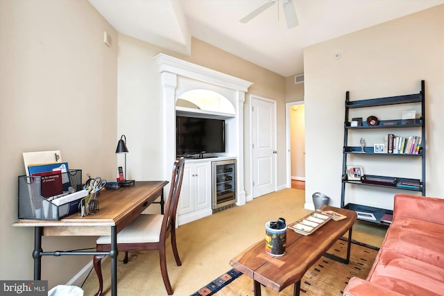 living room with ceiling fan, light carpet, and wine cooler