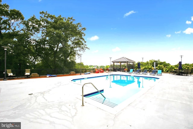 view of swimming pool featuring a gazebo and a patio area