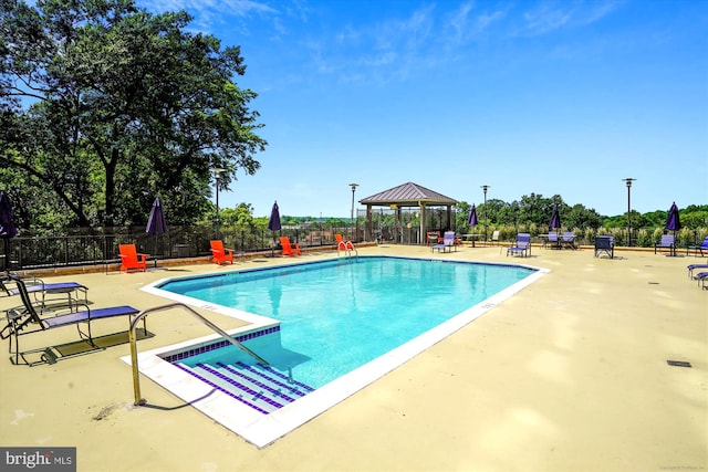 view of swimming pool featuring a gazebo and a patio area