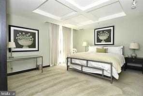 carpeted bedroom featuring beamed ceiling and coffered ceiling