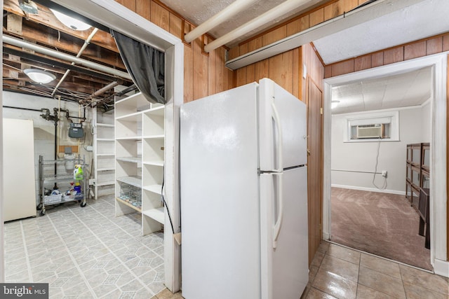 basement featuring wood walls, light colored carpet, a wall mounted air conditioner, and white refrigerator