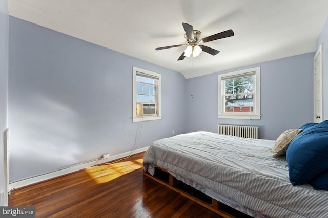 bedroom featuring radiator, ceiling fan, cooling unit, and wood-type flooring