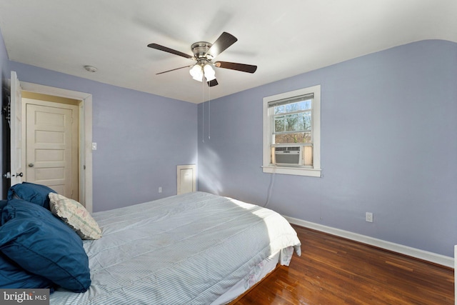 bedroom with ceiling fan, dark hardwood / wood-style floors, and cooling unit