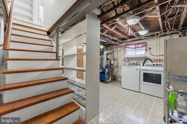 basement with separate washer and dryer and fridge