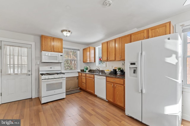 kitchen featuring light hardwood / wood-style floors, white appliances, and sink