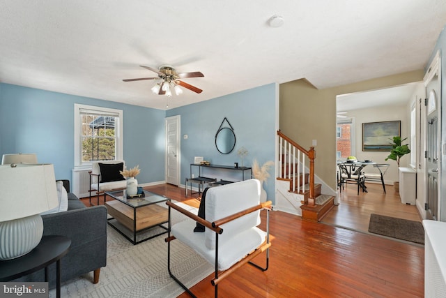 living room with hardwood / wood-style flooring and ceiling fan