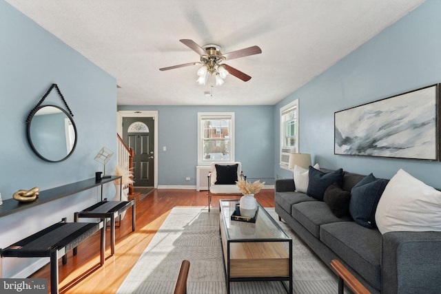 living room featuring ceiling fan and wood-type flooring