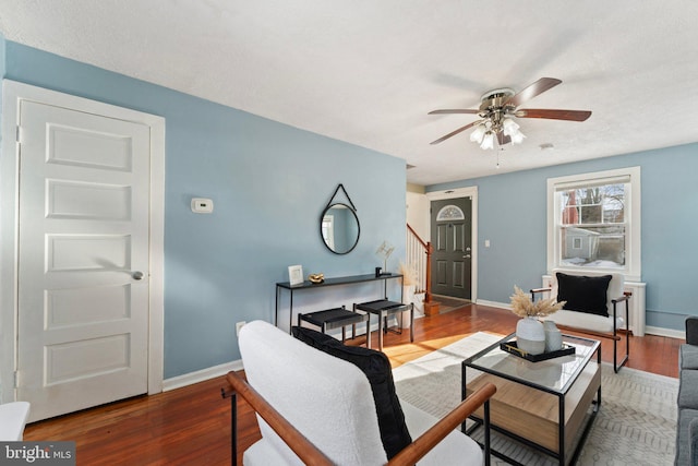 living room featuring hardwood / wood-style floors and ceiling fan