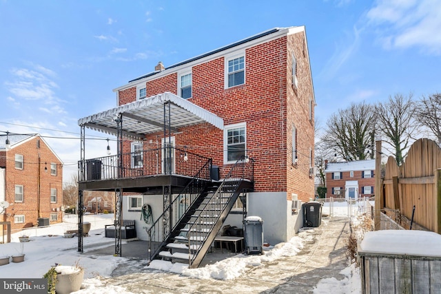 snow covered property featuring cooling unit and a pergola