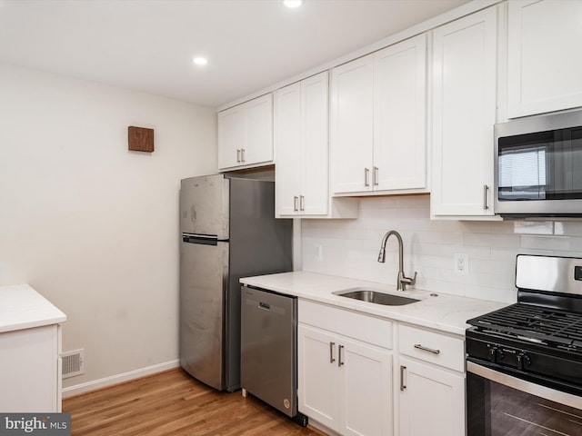 kitchen with white cabinetry, sink, and appliances with stainless steel finishes