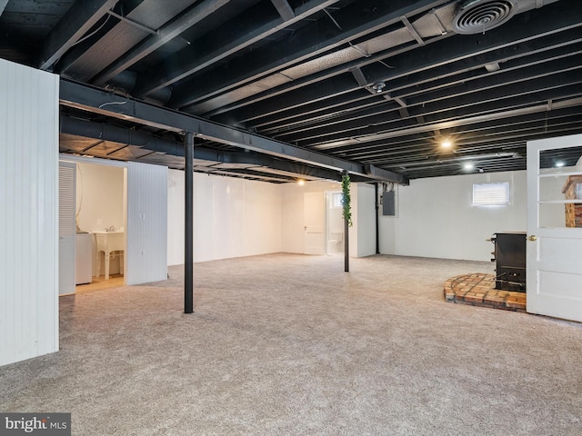 basement featuring washer and clothes dryer and electric panel