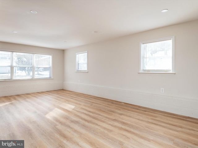 empty room with light hardwood / wood-style flooring