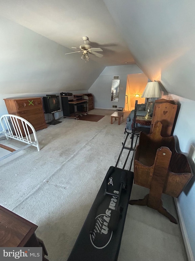 exercise room featuring vaulted ceiling, ceiling fan, and carpet