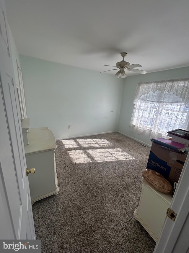 interior space with ceiling fan