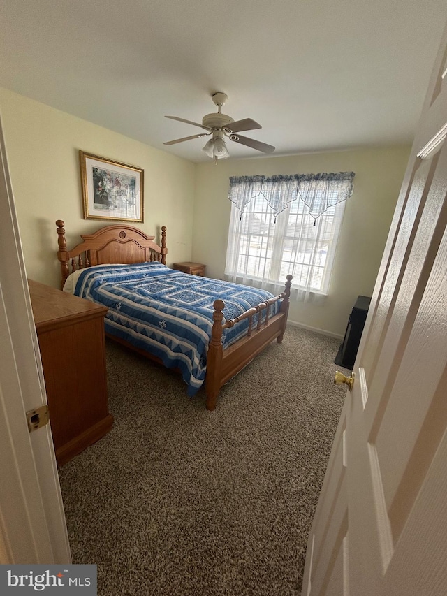 bedroom with ceiling fan and carpet flooring