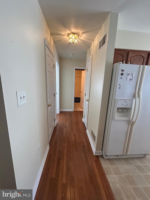 corridor with light hardwood / wood-style floors