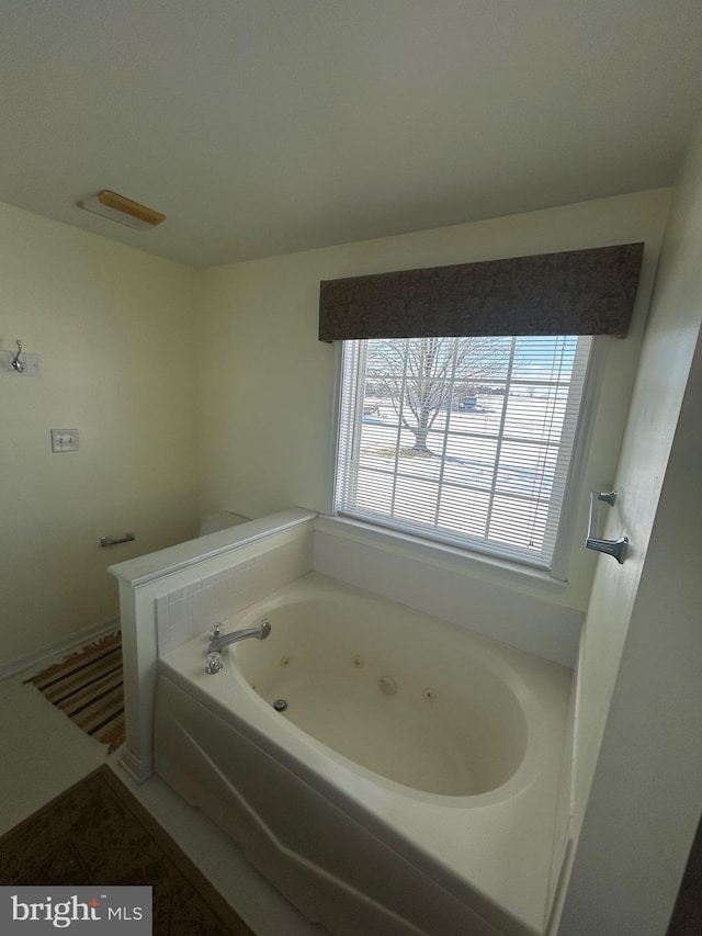 bathroom with a tub to relax in