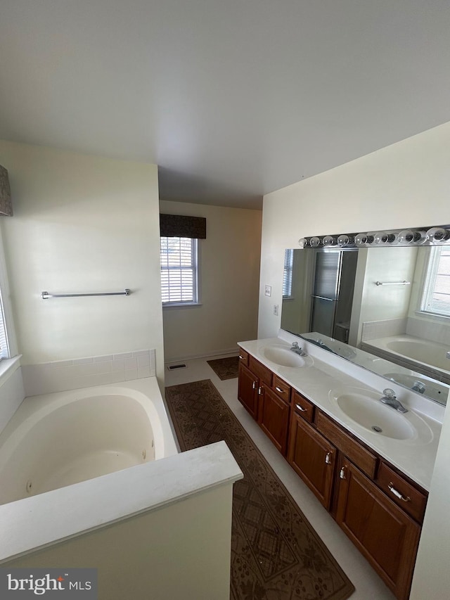 bathroom with a washtub and vanity