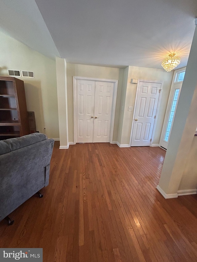 interior space with a chandelier and dark wood-type flooring