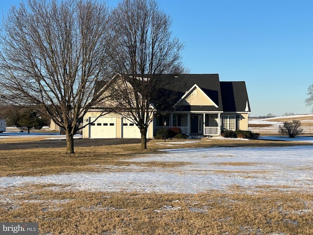 view of front of home featuring covered porch and a garage