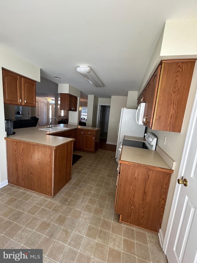 kitchen featuring range, kitchen peninsula, and sink