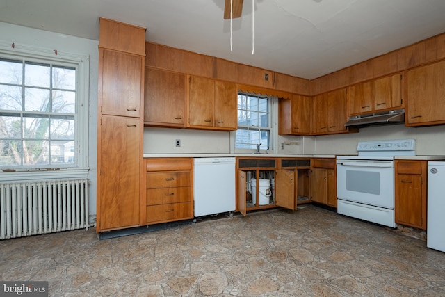 kitchen with sink, white appliances, radiator heating unit, and ceiling fan