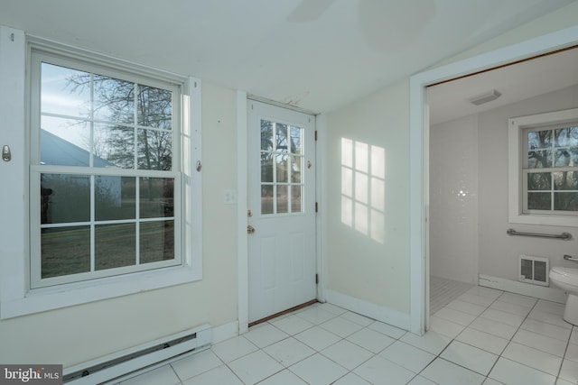 doorway with lofted ceiling, a baseboard radiator, and light tile patterned flooring