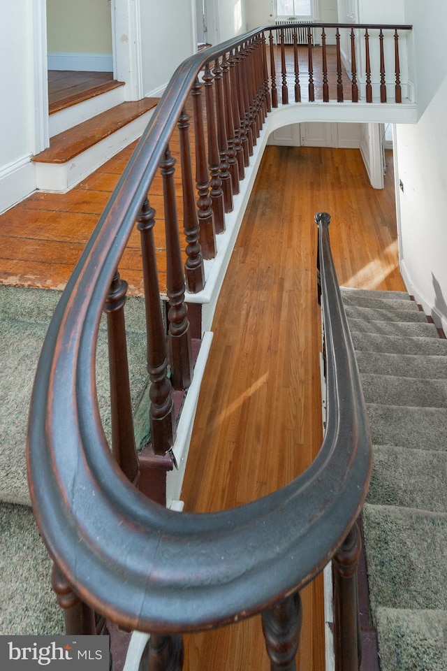 stairs with hardwood / wood-style flooring