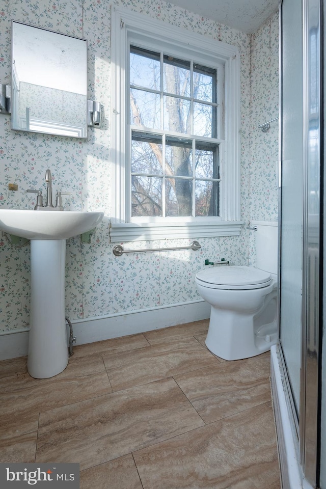 bathroom featuring tile patterned flooring and toilet