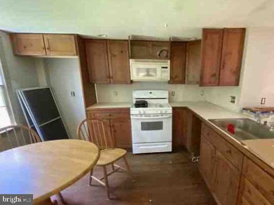 kitchen featuring sink and white appliances