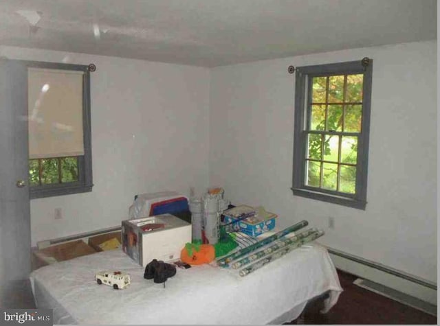 bedroom with a baseboard heating unit