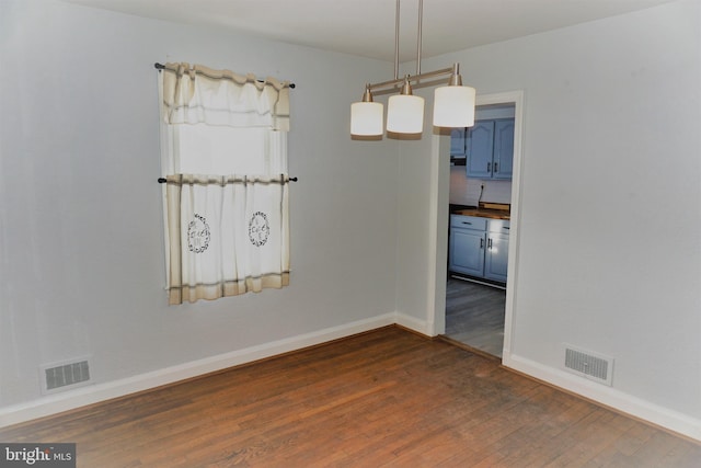 spare room with dark wood-type flooring