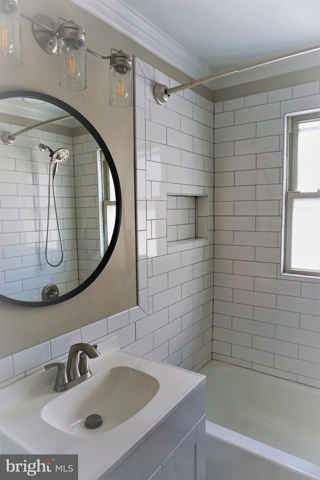 bathroom with vanity, tiled shower / bath combo, and ornamental molding