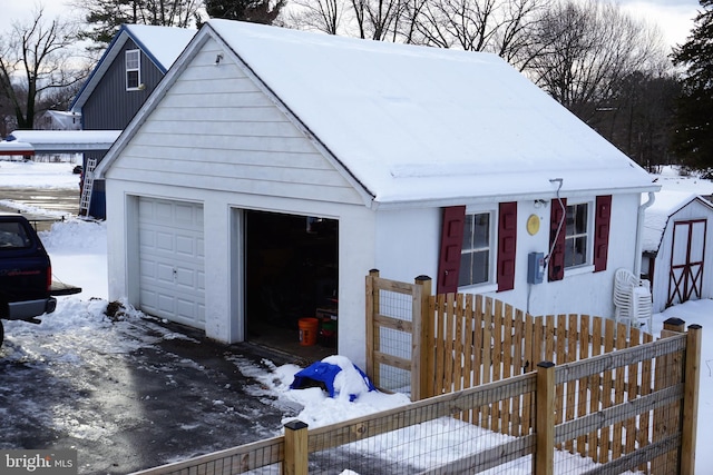 view of front of home with a garage and an outdoor structure