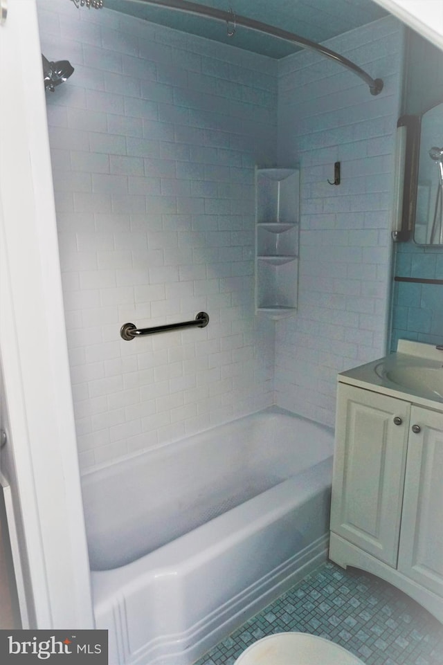 full bathroom featuring tile patterned flooring, vanity, toilet, and tiled shower / bath combo