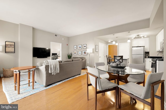 dining space with light hardwood / wood-style flooring