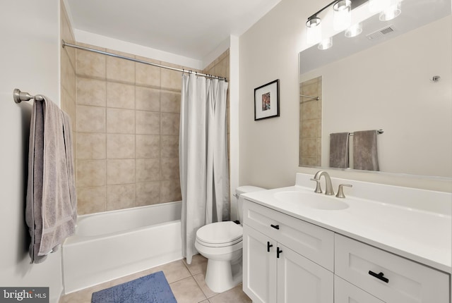 full bathroom with tile patterned flooring, shower / bath combo, vanity, and toilet