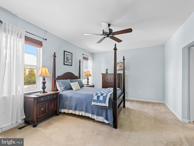 bedroom featuring light colored carpet and ceiling fan