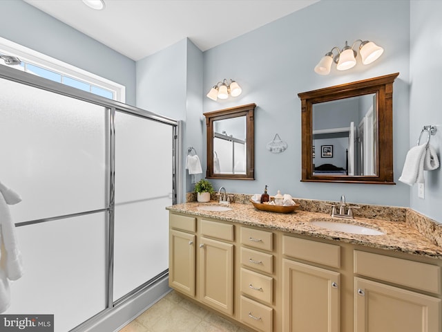 bathroom featuring vanity and a shower with shower door