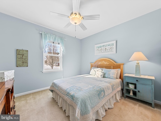 bedroom with ceiling fan and light carpet