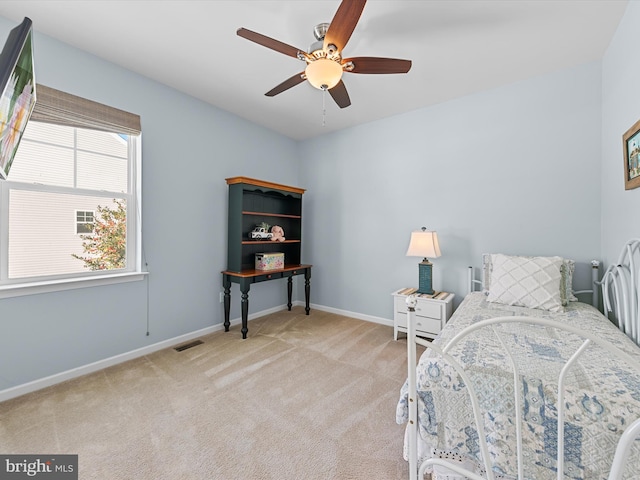 bedroom with ceiling fan and light carpet