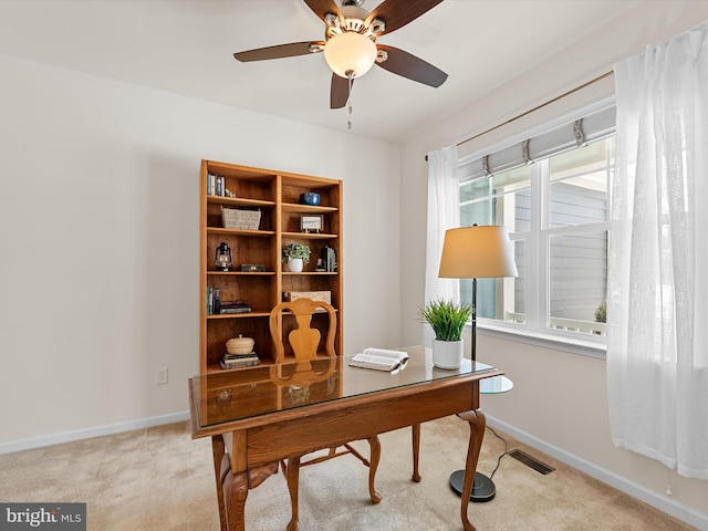 office space with light colored carpet and ceiling fan