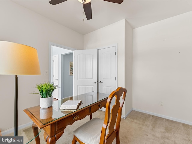 carpeted office space featuring ceiling fan