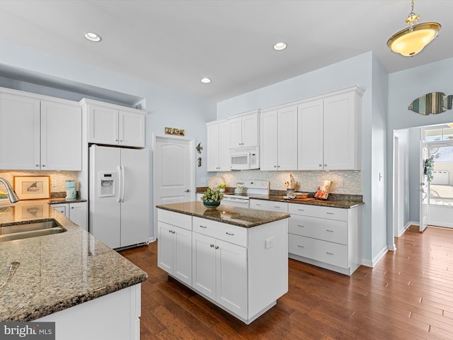 kitchen featuring sink, white cabinets, and white appliances