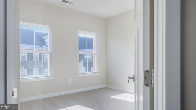 unfurnished room with light colored carpet